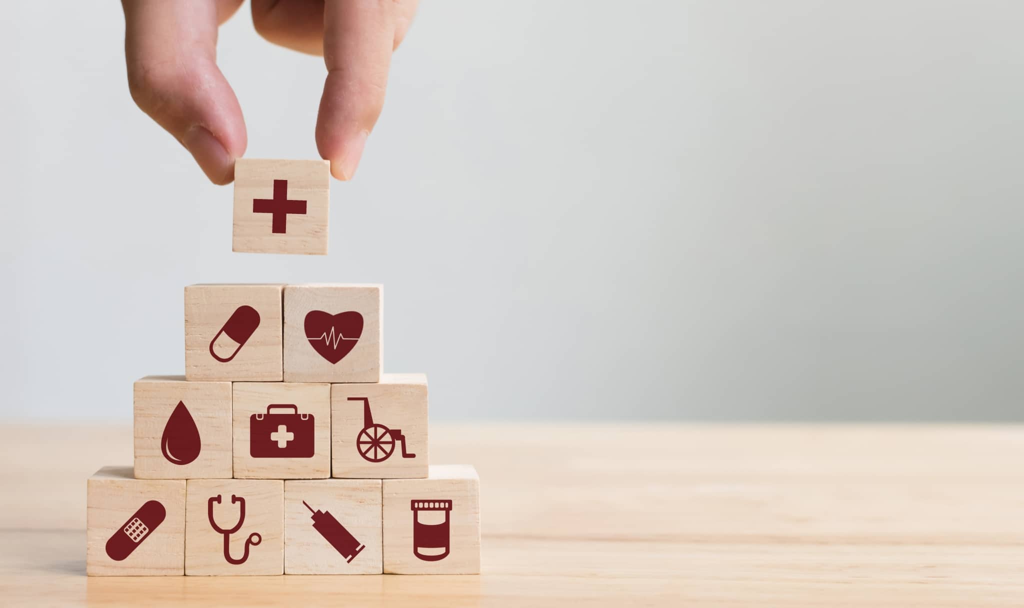 Hand arranging healthcare building blocks