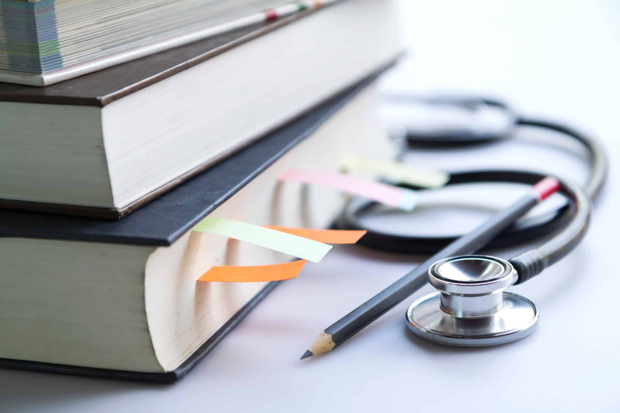 Textbooks next to a stethoscope