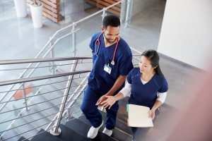 Two medical professionals on a staircase