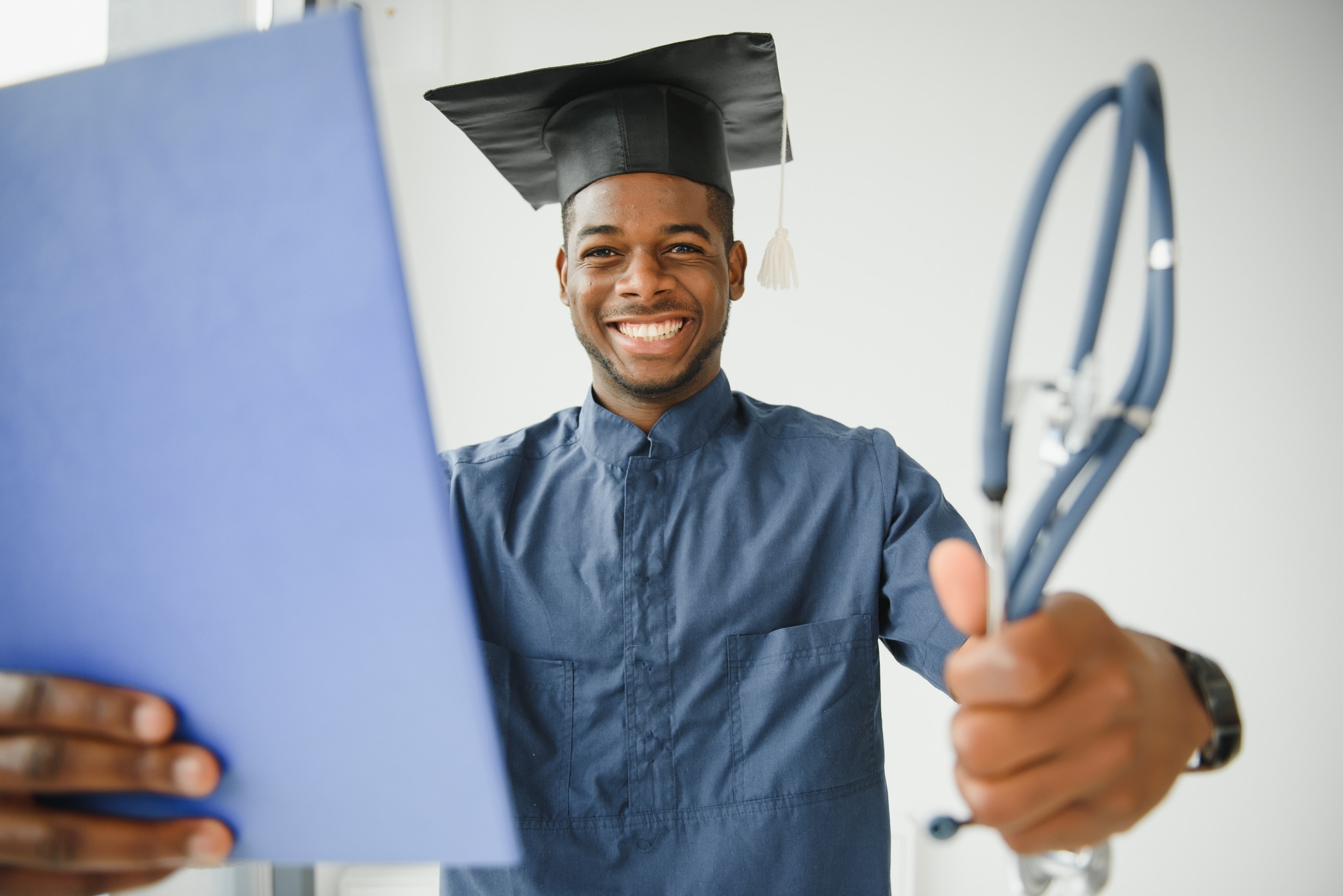 African-American man with a stethoscope in a graduation cap