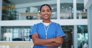 Smiling nurse with her arms crossed in a hospital