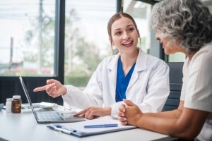 Caucasian medical professional speaking with an older patient