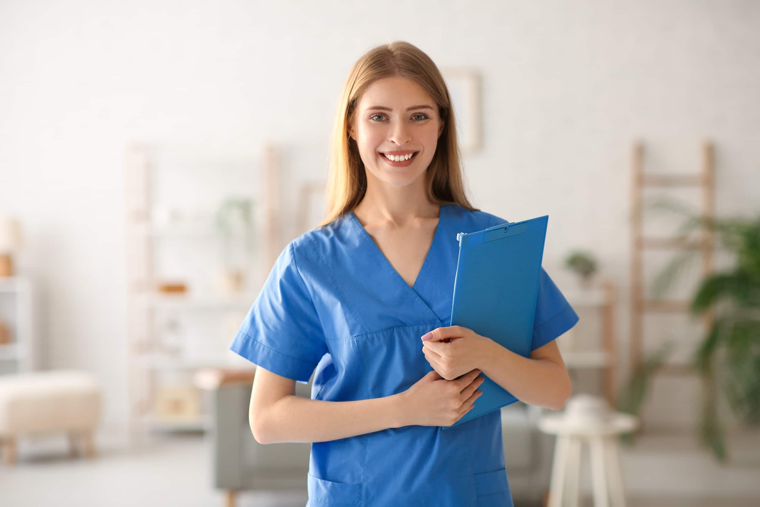 Smiling medical professional in blue scrubs