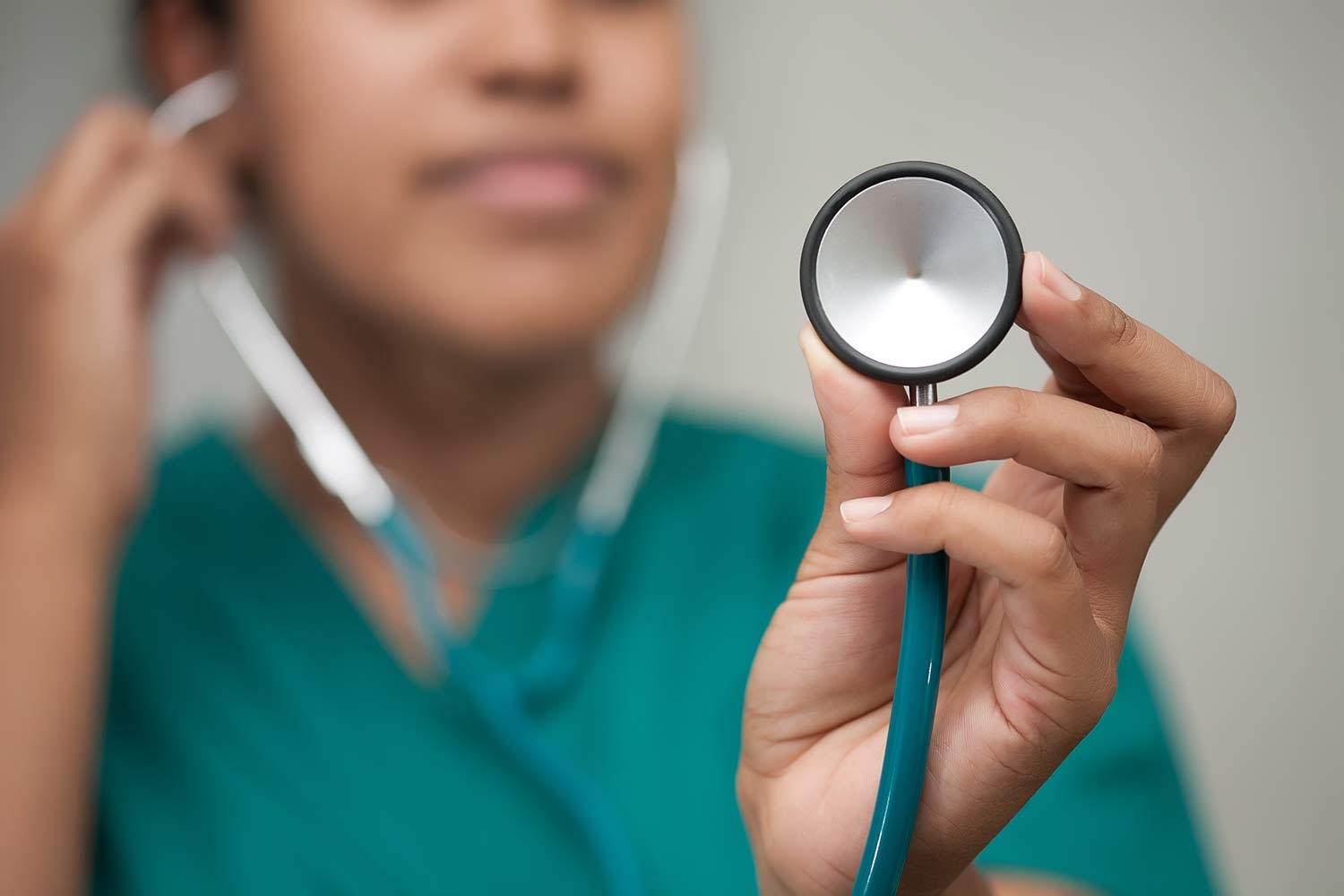 Blurred image of a nurse holding a stethoscope