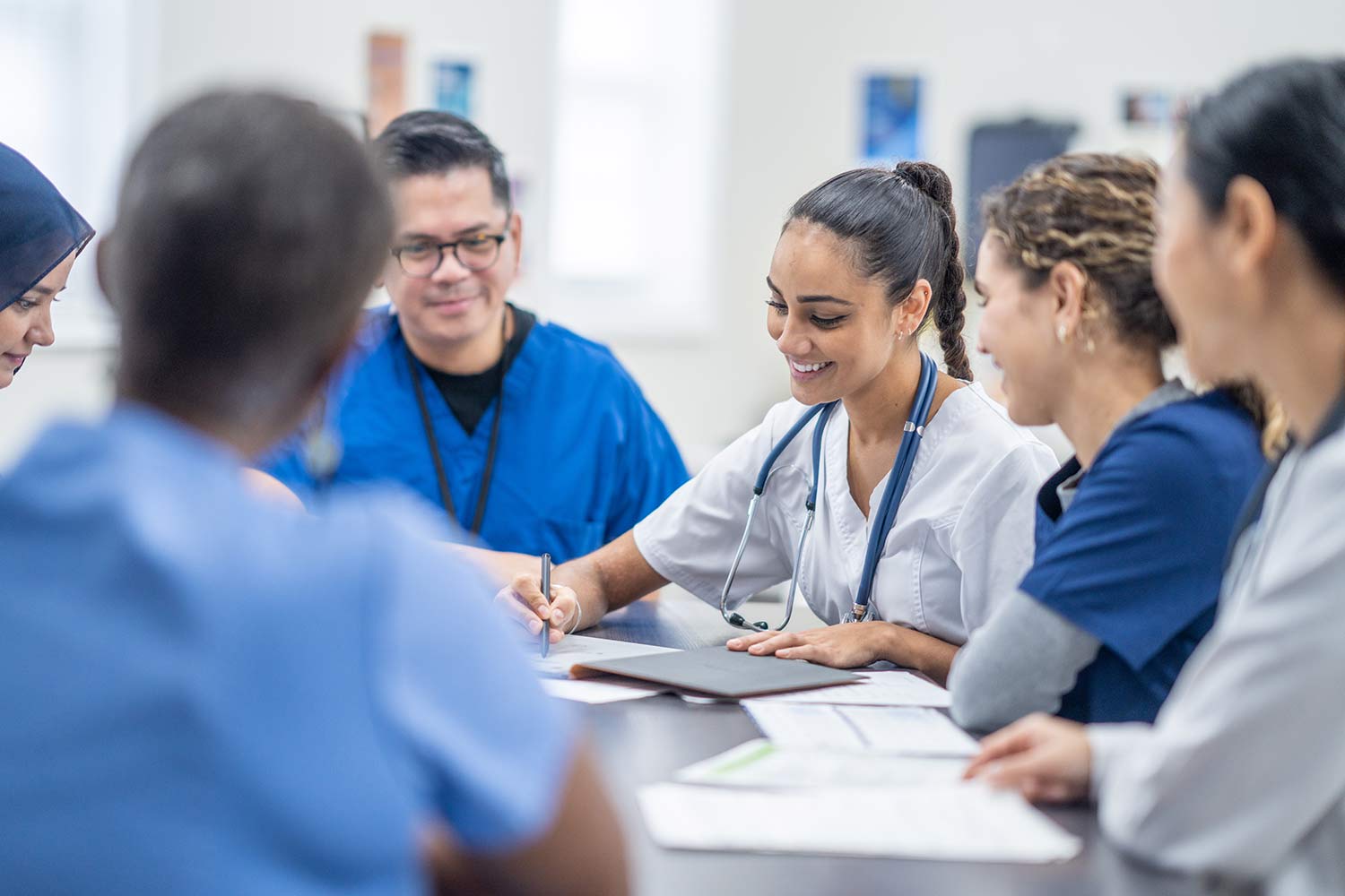 Diverse medical professionals sitting around a table